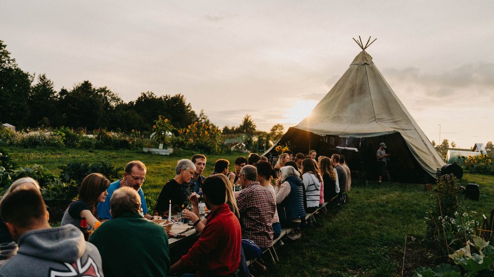 A long table dinner at a Roots site
